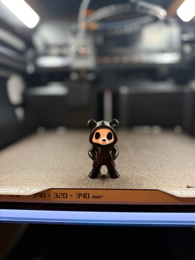 A custom figure mid-print on the 3D printer bed